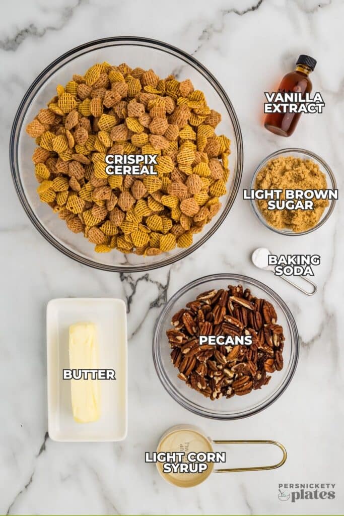 Labeled ingredients for butter pecan snack mix on marble background.