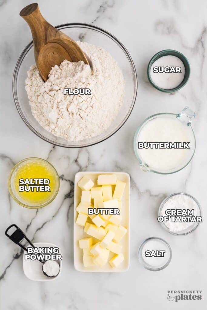 A flat-lay of labeled biscuit ingredients spread out on a white countertop.