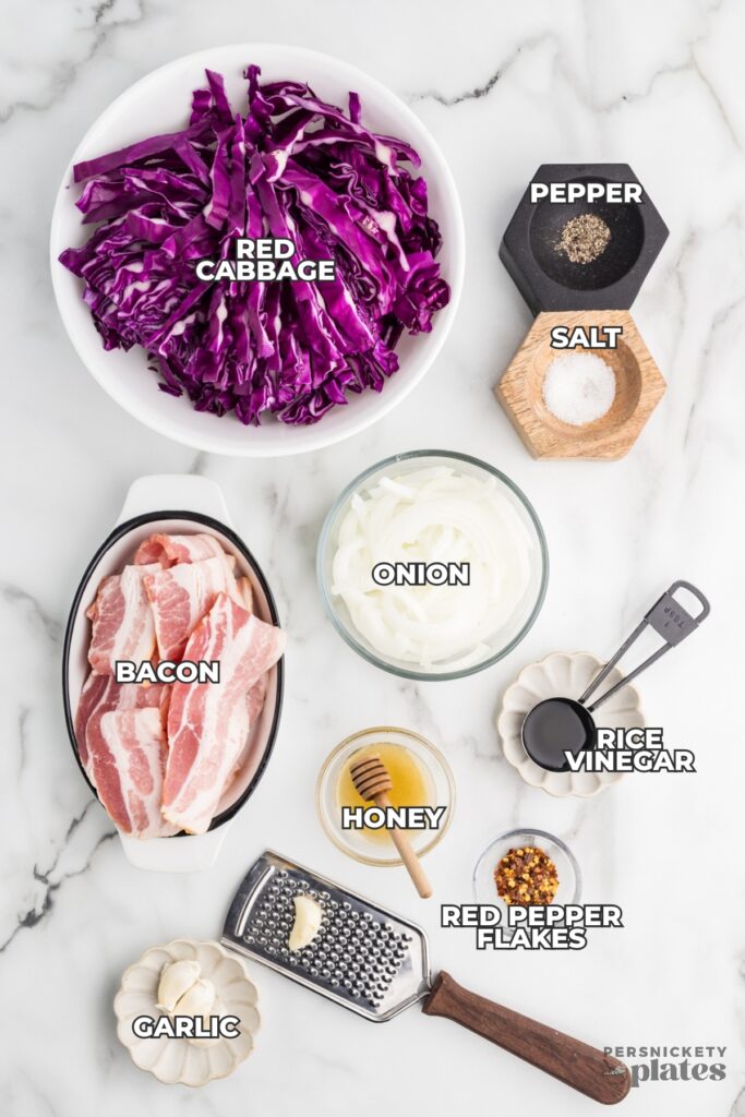 Ingredients for stir fried red cabbage labeled on a marble surface.