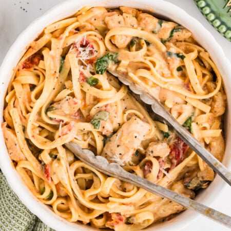 Creamy chicken pasta with sun-dried tomatoes in a bowl.