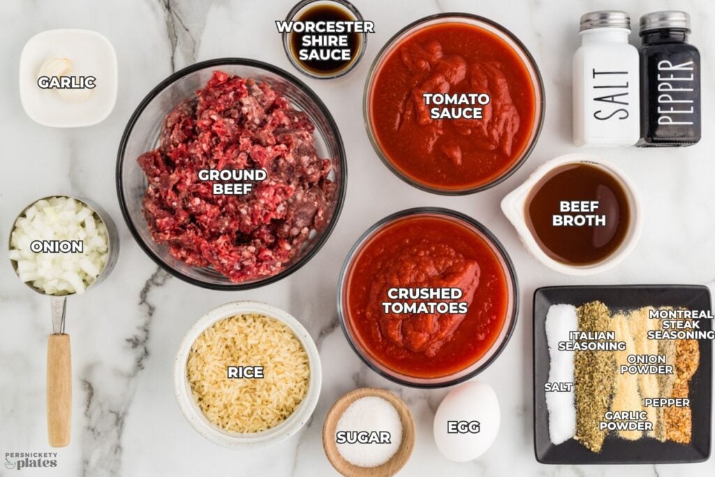 Labeled ingredients for slow cooker porcupine meatballs arranged on a white marble countertop.
